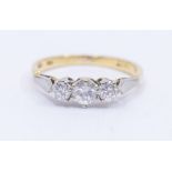 A three stone diamond and 18ct gold ring, comprising three graduated round brilliant cut diamonds,