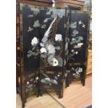 A mid 20th century Chinese black lacquered room screen decorated with bird and foliage detail