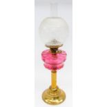 A 19th century ruby glass and brass oil table lamp.