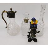 A collection of cut-glass decanters, claret jug, condiments, vintage glass clown