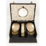 A fabric cased Birmingham silver mounted vanity part set, to include folding mirror, comb and