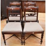 A set of four late Georgian mahogany dining chairs
