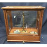 Four late 19th to early 20th century scales in mahogany and glass cases