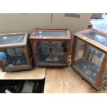 Three early 20th century scales in mahogany and glass cases.