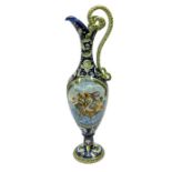 A large Cantagalli style ewer, with large entwining serpent style handles, the front painted with