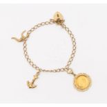 A 9ct gold charm bracelet suspending an anchor, horse shoe, padlock clasp and an Isle of man 1/20