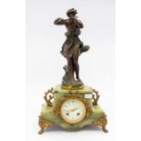 A French two-train mantel clock with a cast bronze style figure playing a flute next to a tree. A