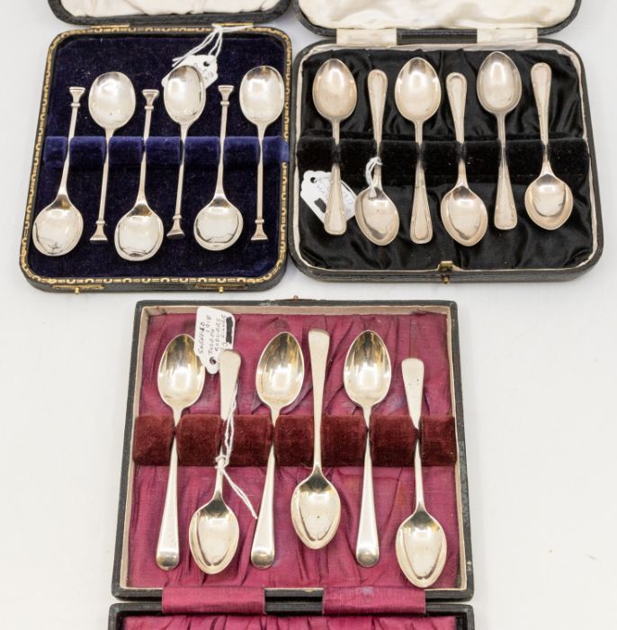 A collection of three cased sets of spoons to include; A Birmingham silver seal like topped set of