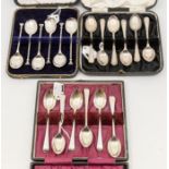 A collection of three cased sets of spoons to include; A Birmingham silver seal like topped set of