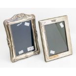 Two silver frames to include; An embossed and plain designed silver frame with fabric easel form