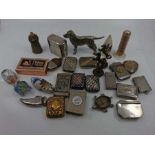 An assortment of silver plated, novelty and other vesta cases. A figure of a dog, brass prancing