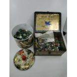 Two tins of marbles to include some early 20th century examples etc.