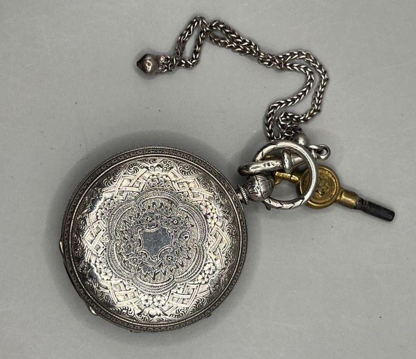 A sterling silver key wound pocket watch in ornamental case decorated with forget me nots and - Image 3 of 3