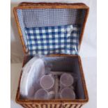 A wicker basket picnic set, with Blue Gingham lining , plastic knife and  forks and plates