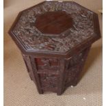 An early 20th century carved Oriental hardwood occasional table on folding stand, a pair of