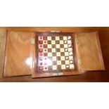 A complete boxed travel fold away chess set, plastic pieces, measures 50cm x 25 cm when unfolded,