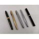 A selection of fountain pens, comprising a Shaeffer fountain pen in yellow metal, with a 14k nib;