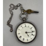 A sterling silver key wound pocket watch in ornamental case decorated with forget me nots and