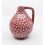 A Bjorre Keramikk Norwegian studio pottery handled vase with red glazed white polka dot design,
