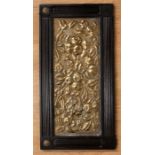 An Arts & Crafts hammered designed brass panel probably from a fireplace with decorative fruit and
