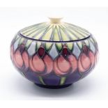 A Moorcroft Pottery powder bowl and cover in the 'April Tulips' pattern, signed by Emma Bossons