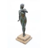 An Art Deco bronzed figure of a nude female posing on tip-toes, on an Art Deco style two stepped