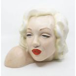 A moulded ceramic bust of Marilyn Munroe with painted detail to facial features and hair, marked