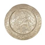A 20th century pewter charger of a 16th century designed copy with embossed text, jester and