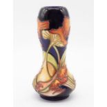 A Moorcroft pottery gourd shaped vase, decorated with dancing parasols pattern, painted and