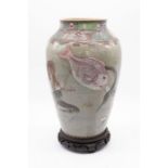 A Japanese porcelain vase with layered sea creature design with a multicoloured stylised design to