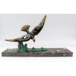 A French bronzed spelter sculpture of a bird in flight over a large wave, on large rectangular