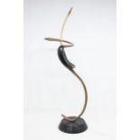 An abstract large decorative cast metal sculpture of a pair of wading birds possibly Egrets,