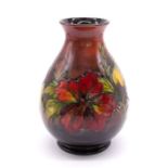 Moorcroft Pottery: A Moorcroft flambe 'Hibiscus' pattern baluster vase. Height approx 20.5cm.