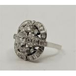 A platinum diamond cluster ring, claw set central marquise-cut diamond (EDW approx. 0.50 carats)