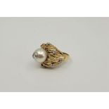 An 18ct. gold, diamond and cultured pearl dress ring, the large foliate form mount set eight prong