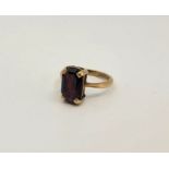 A 9ct. gold and garnet dress ring, claw set emerald cut garnet, size UK M. (gross weight 4.0g)