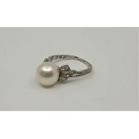 A 14ct. white gold, cultured pearl and diamond ring, set single cultured pearl to centre, with