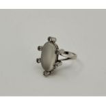 An 18ct. white gold, moonstone and diamond ring, set central marquise cabochon moonstone bordered by