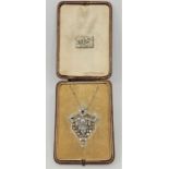 An Art Deco precious white metal and diamond set pendant/brooch, of typical geometric design, having