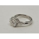 An 18ct. white gold and diamond ring, claw set central round brilliant cut diamond (EDW approx. 2.29