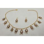 An 18ct. gold, ruby, clear stone, opal and seed pearl set fringe necklace and earrings en suite, the