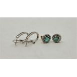 A pair of 18ct. gold, emerald and diamond oval cluster earrings, each set mixed oval cut emerald