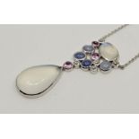 An 18ct. white gold, moonstone, diamond, cabochon sapphire and cabochon ruby pendant necklace,