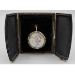 An Edwardian 9ct gold and seed pearl mourning pendant, set with portrait miniature of an infant,