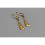 A pair of winged filigree gold drop earrings, one stamped 21k. 4.1gm