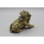 A Chinese gilt bronze Kylin, 20th century. Modelled with head turned and juvenile clinging to