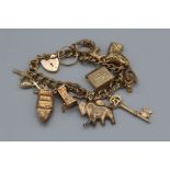 A 9ct gold charm bracelet, eleven charms plus a heart padlock, approximately 33.8gm