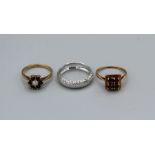 Three rings, comprising a white metal 9k stamped ring (0.8gm approximately), a garnet dress ring,