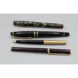 A selection of pens. Comprising a black and yellow metal Waterman fountain pen in a Waterman