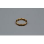 A 22ct gold band ring., hallmarked Birmingham 1926. Size N. Approximate weight 4.3 grams.